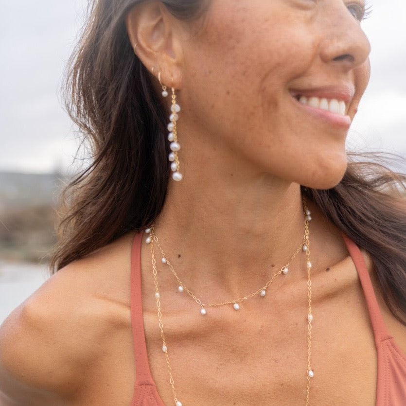 The Kalaheo Earrings worn, pearls resting just below the earlobe