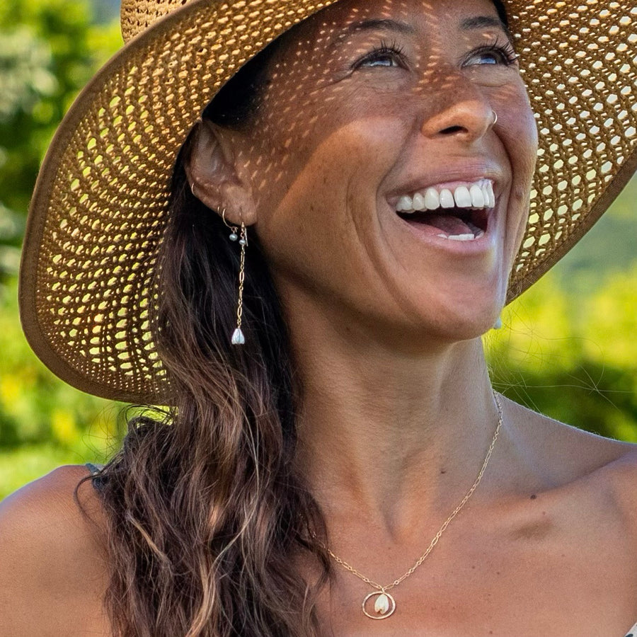 The Pikake Necklace worn at the collarbone in natural daylight